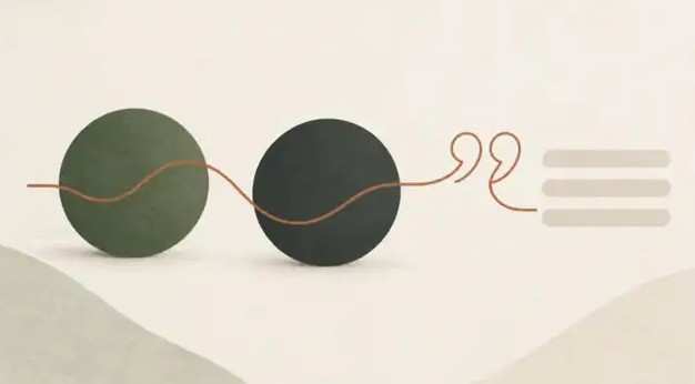 Illustration of two spheres joined by a line that ends in a quotation mark and text lines